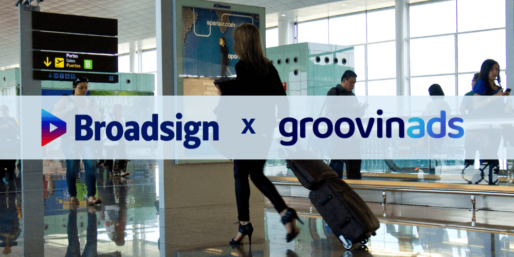 Broadsign and Groovinads logos over an airport scene with travellers walking through a terminal.