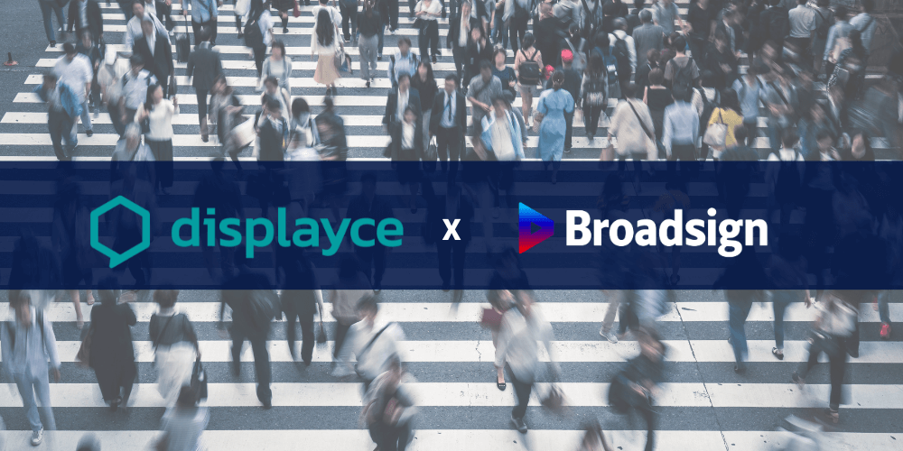 Displayce and Broadsign logos displayed over a busy pedestrian crosswalk.