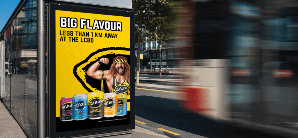 Mike’s Hard Lemonade digital out-of-home ad promoting bold flavours near an LCBO, displayed beside a city street.