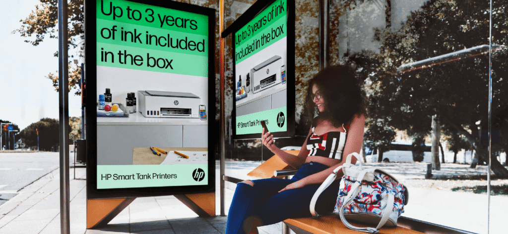 HP Smart Tank Printers digital out-of-home ads promoting up to three years of included ink at a bus shelter.