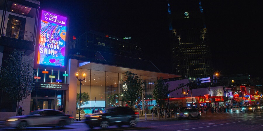 A large digital OOH ad displayed at roadside at Fifth + Broadway