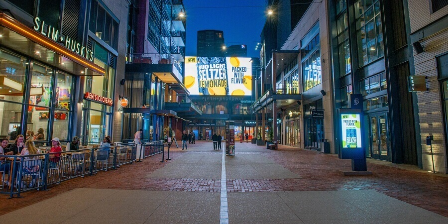 An image of the street at Fifth + Broadway underneath a giant ad for hard seltzer