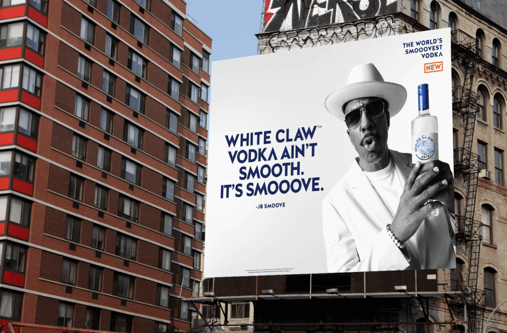 White Claw Vodka billboard featuring a spokesperson holding a bottle, displayed between urban buildings.
