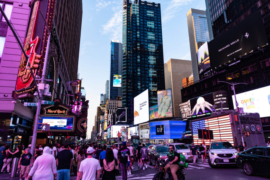 Times Square featuring large digital out-of-home billboards and illuminated brand advertisements surrounded by skyscrapers.
