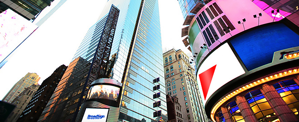Upward view of skyscrapers and large digital billboards in Times Square, New York City.